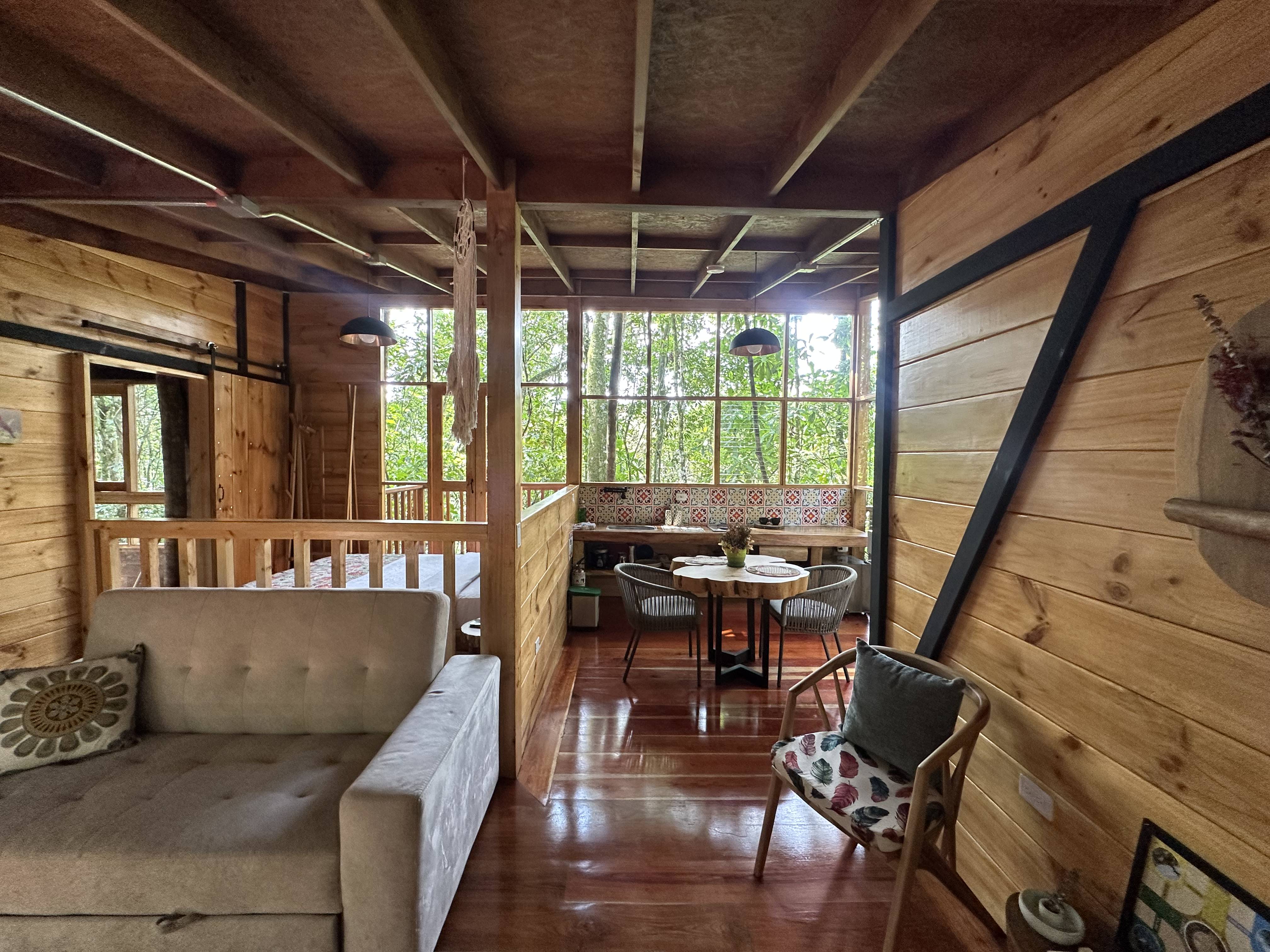 Comfortable interior of La Esmeralda eco-lodge with wooden construction and forest views