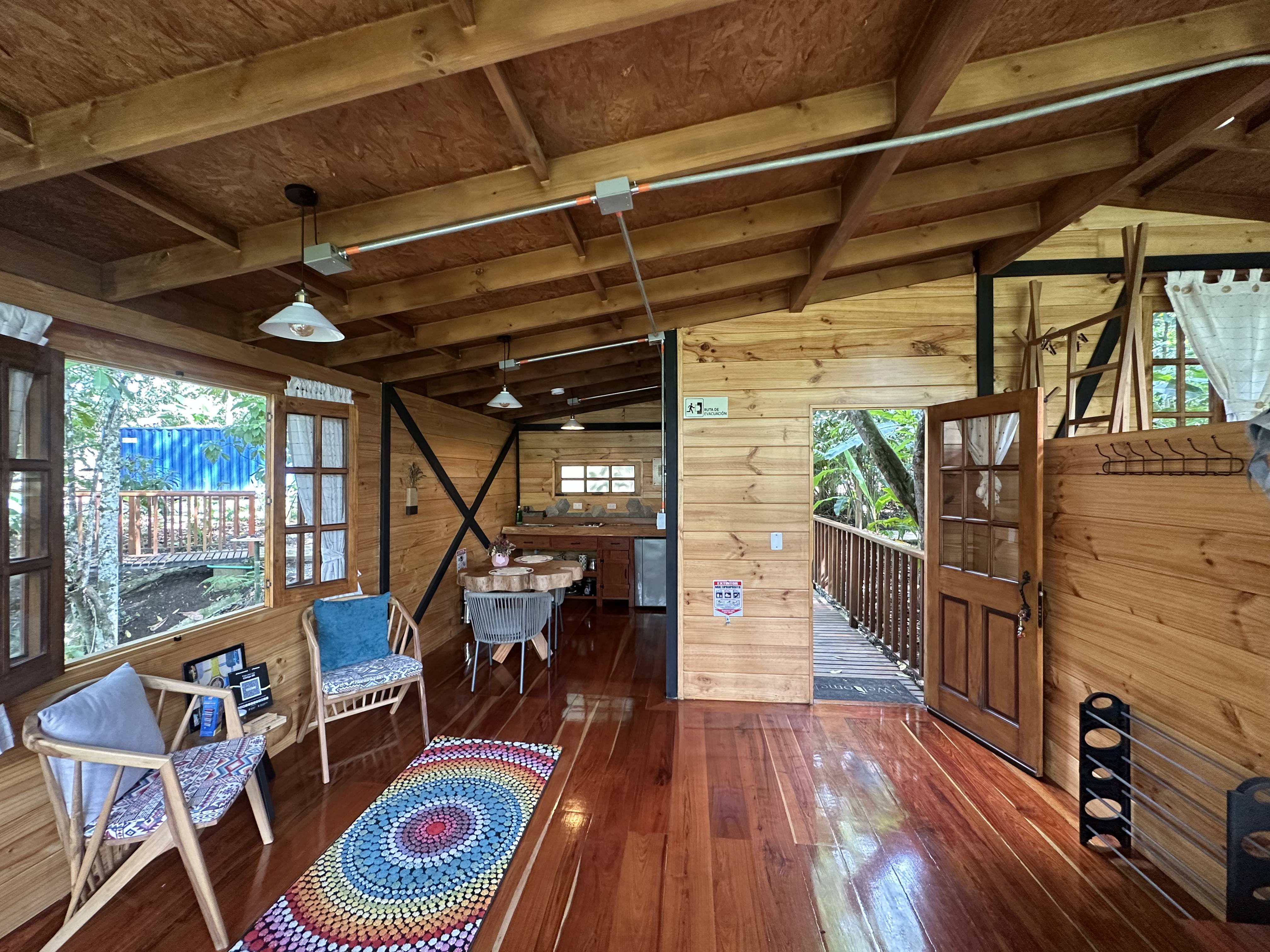 Open-plan interior of La Esmeralda lodge showing sustainable design and forest integration